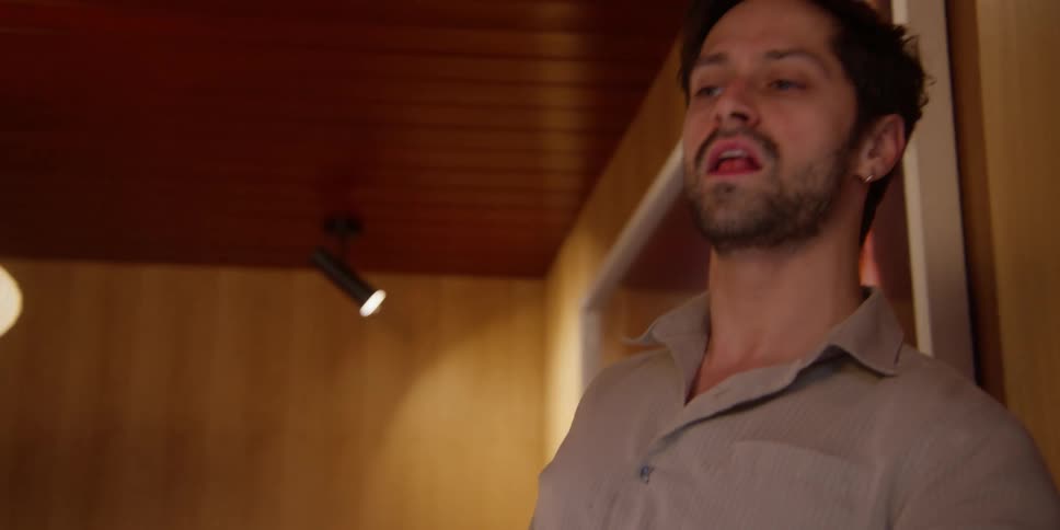 A man doing artistic performance while cleaning the floor with a utensil