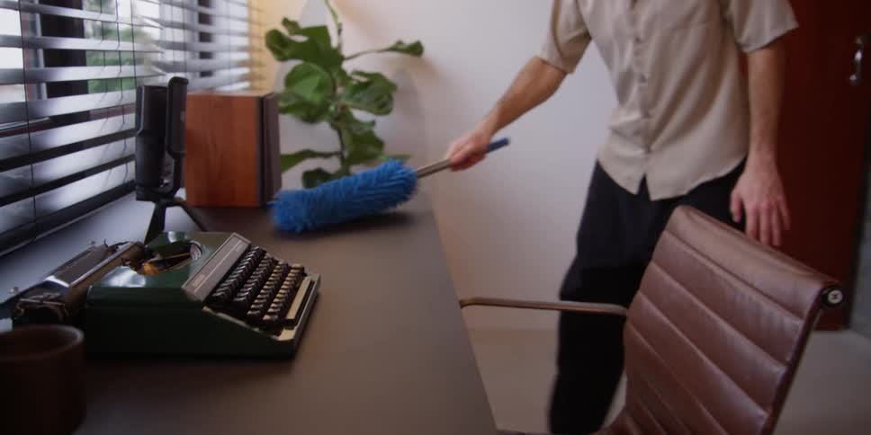 Man cleaning an office desk