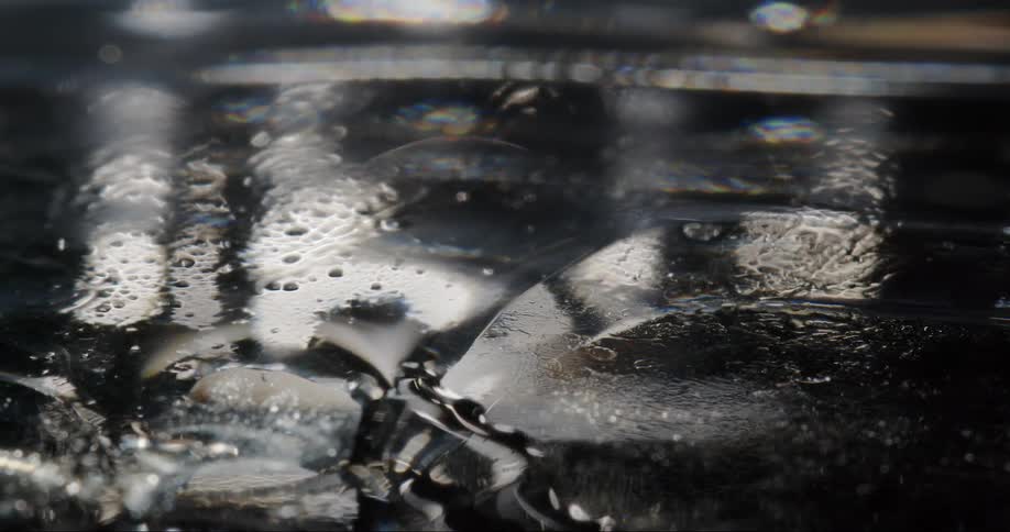 A black surface with a small puddle of water