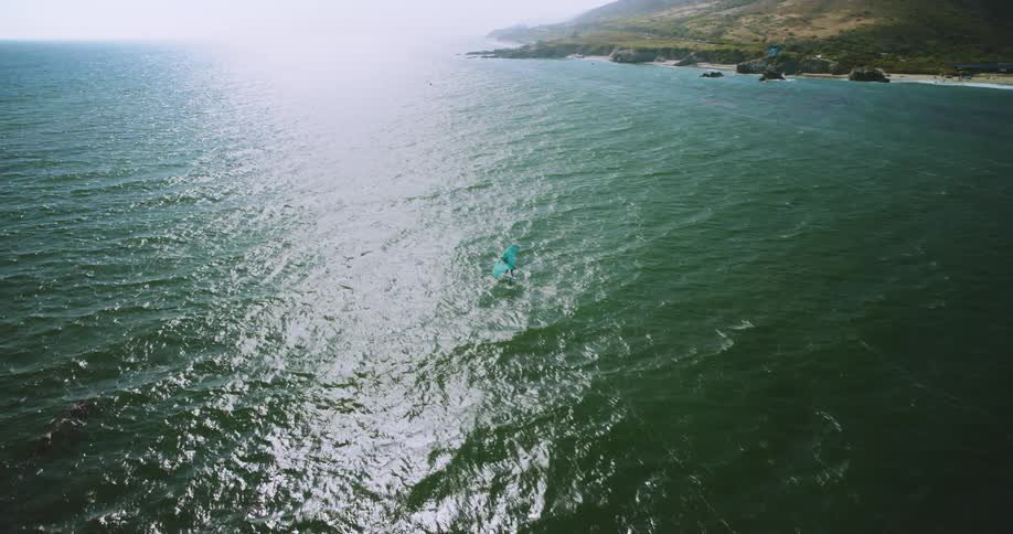 A person is kite surfing in the ocean