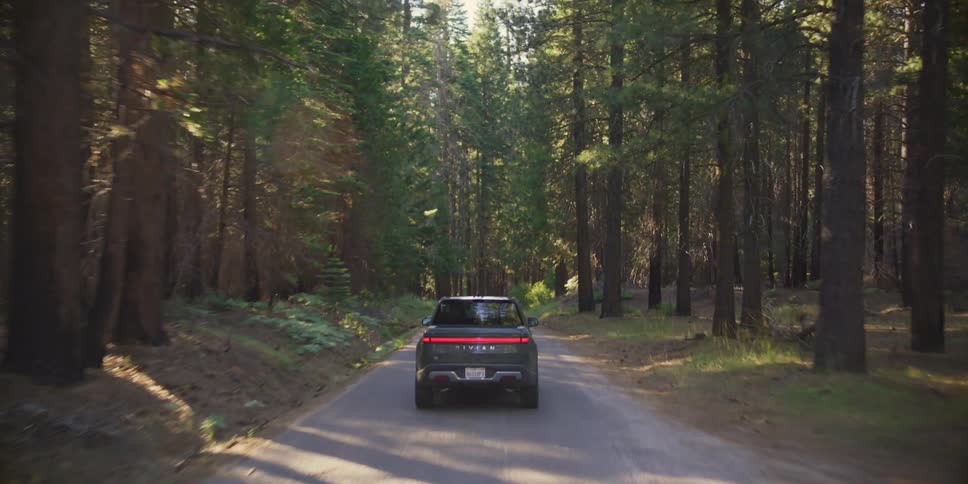 A clip of a vehicle moving on the freeway in the woods