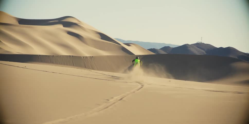 A clip of person diving a motorbike in the desert