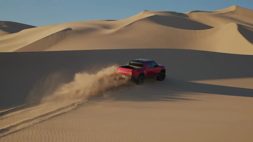 A pickup truck driving across the desert