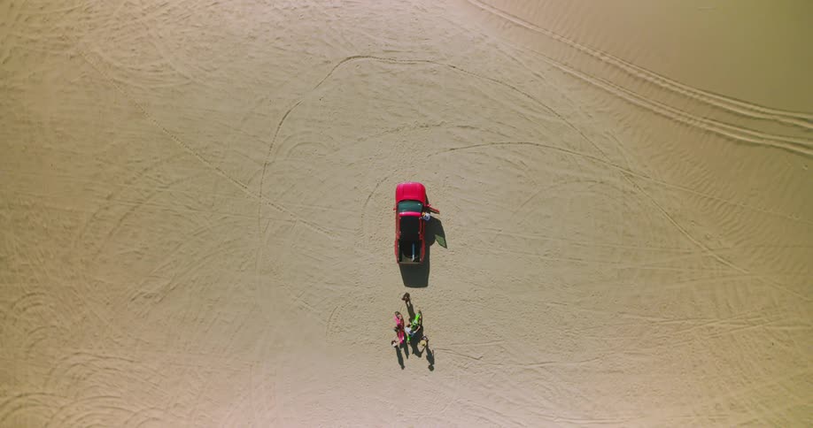 Two motorcycles and a pickup truck in the middle of the desert