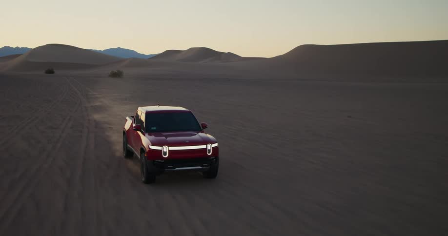 Red truck traveling through the desert