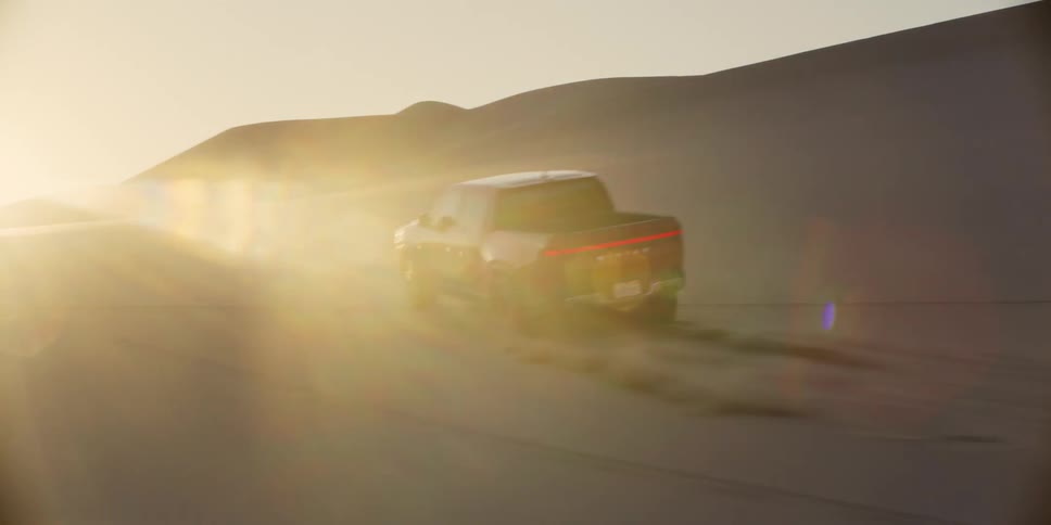 A pickup truck driving across the desert