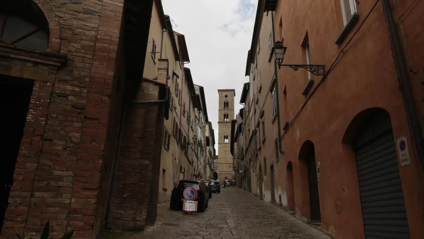The long alley has buildings on either side