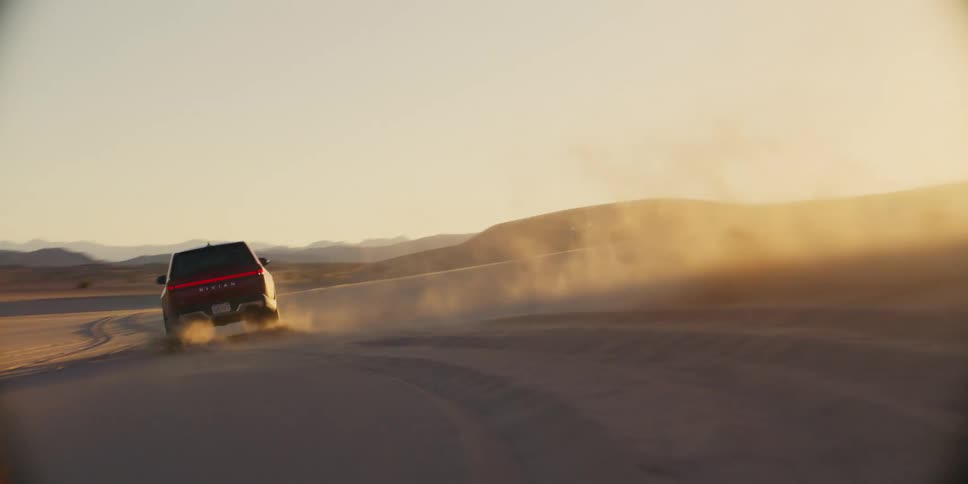 A truck drives around in the sand
