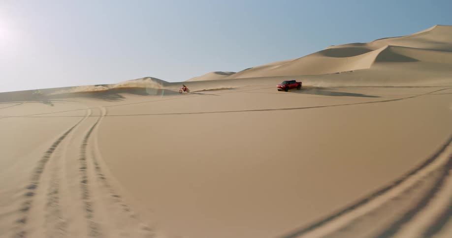 A clip of a truck and two motorbikes racing