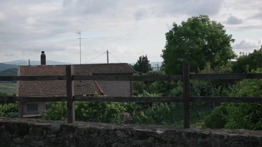 A red tiled building near some trees