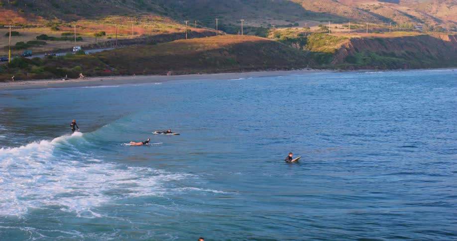 A wide shot of surfers in the sea