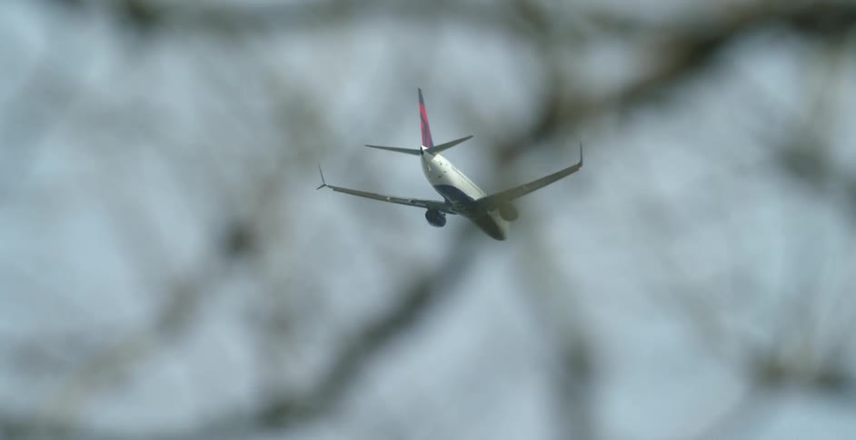 A plane is flying during the day