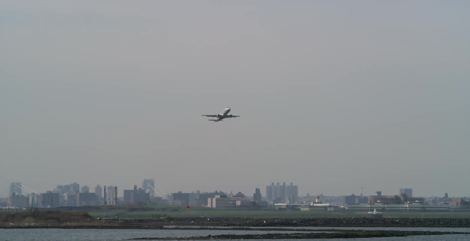 An airplane taking off near a big city