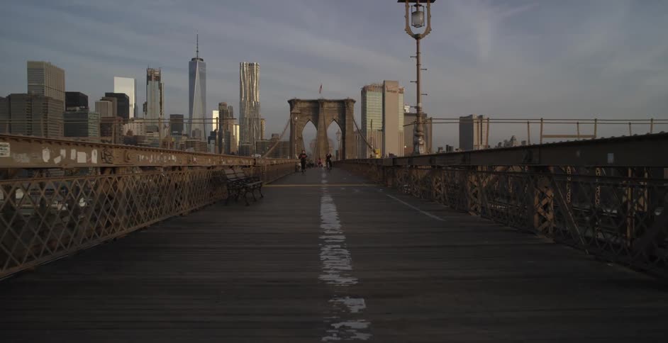Moving view across a bridge towards a large city