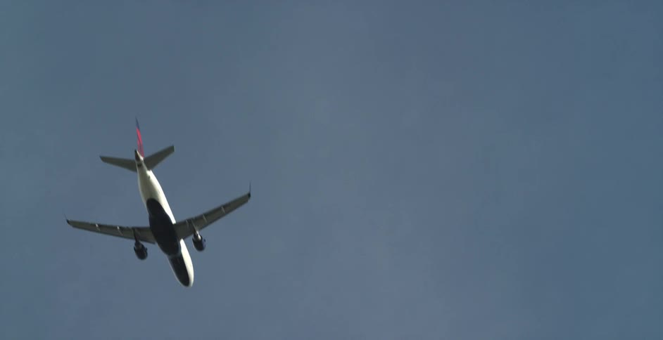 An airplane flies high in the sky