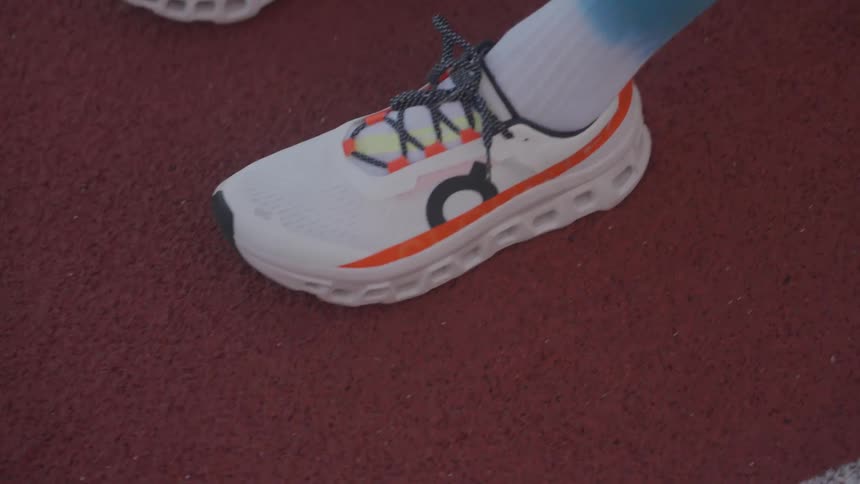 A young man is sitting on the floor wearing sports shoes and long socks