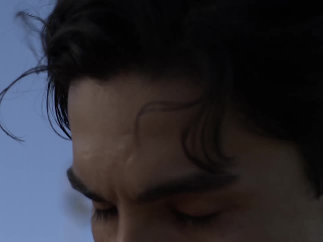 Portrait of a man shaking his hair while having a facial expression of concentration