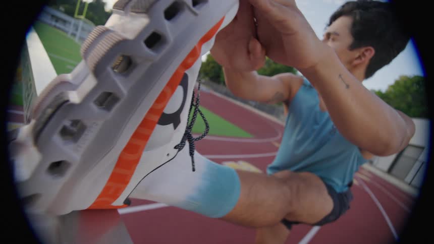 A man is stretching on the track