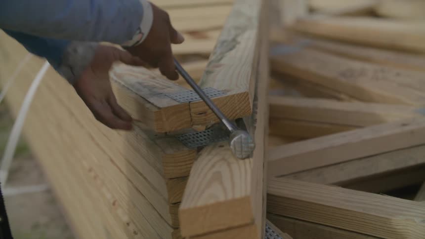 A framer is working on a construction site