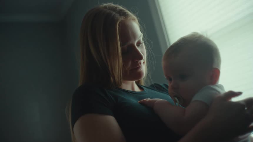 A mother holds and provides comfort for her baby