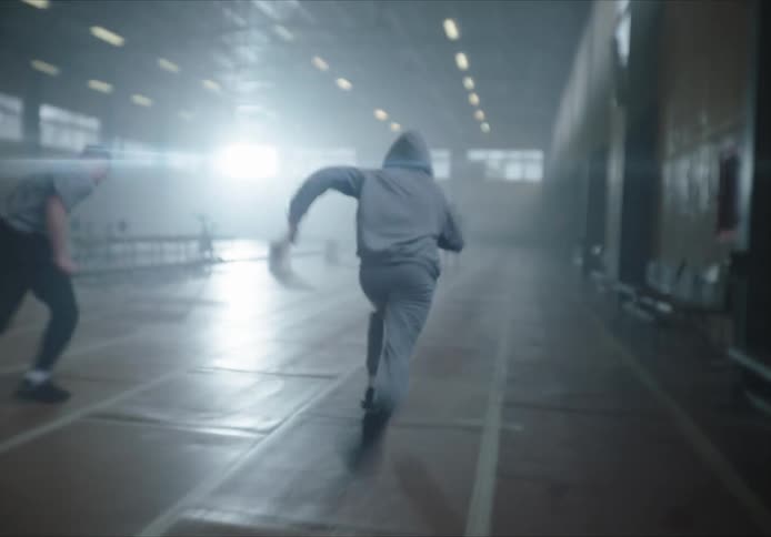 Two men racing against each other on a gym track