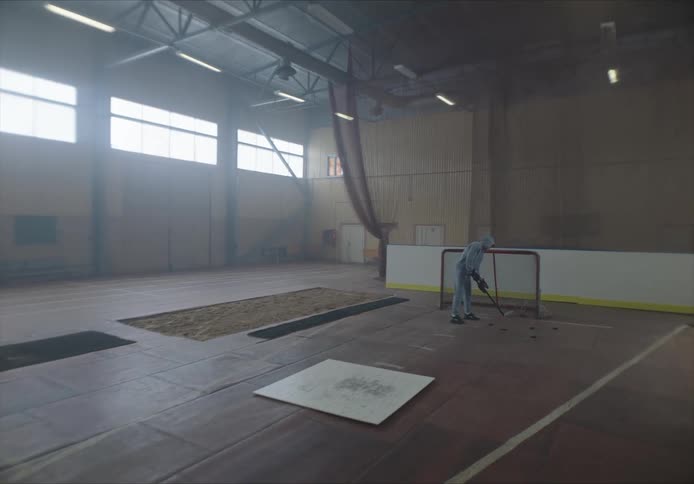 A clip of a person cleaning a hockey court