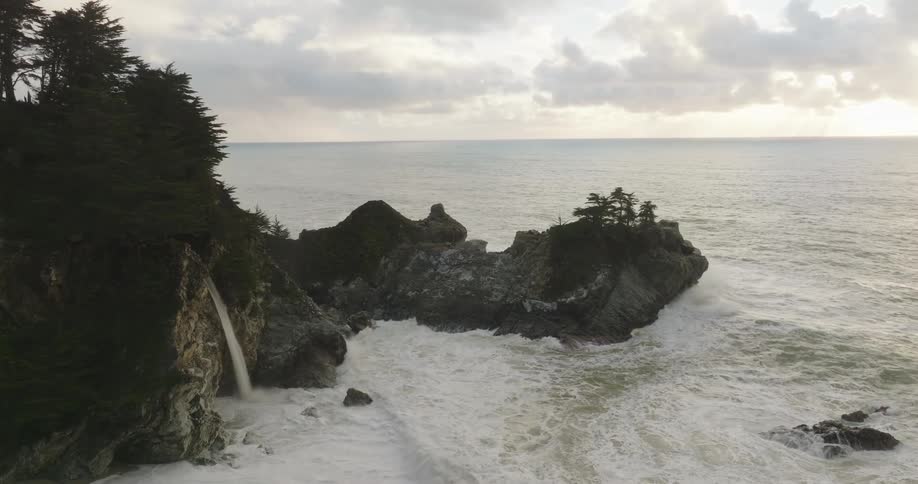 Strong ocean waves crash against coastal rocks