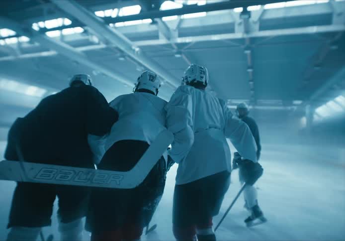 People helping an injured hockey player