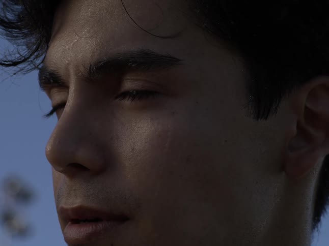 Portrait of a sweaty concentrated man opening his eyes with facial expression of determination