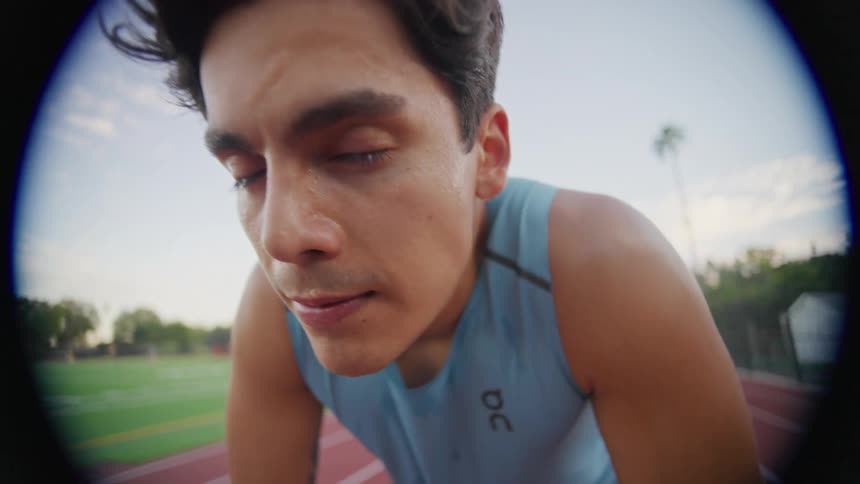 Portrait of a man with a facial expression of determination and concentration on an athletics track