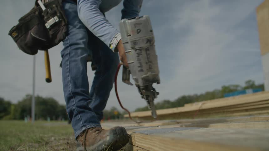 A man using a power tool at a construction site