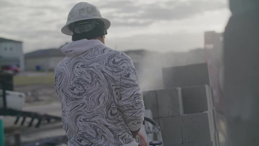 Man clenching a concrete block