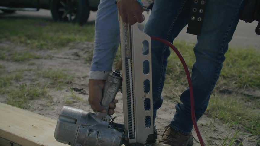 A person drilling wood with a power tool