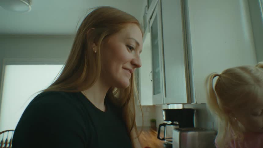 Mother and daughter washing dishes in the kitchen