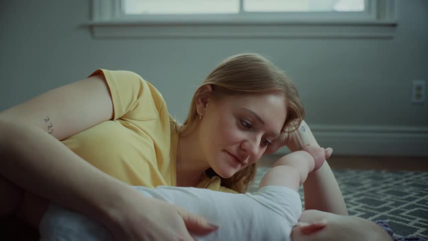 A mother enjoys cuddling with her infant