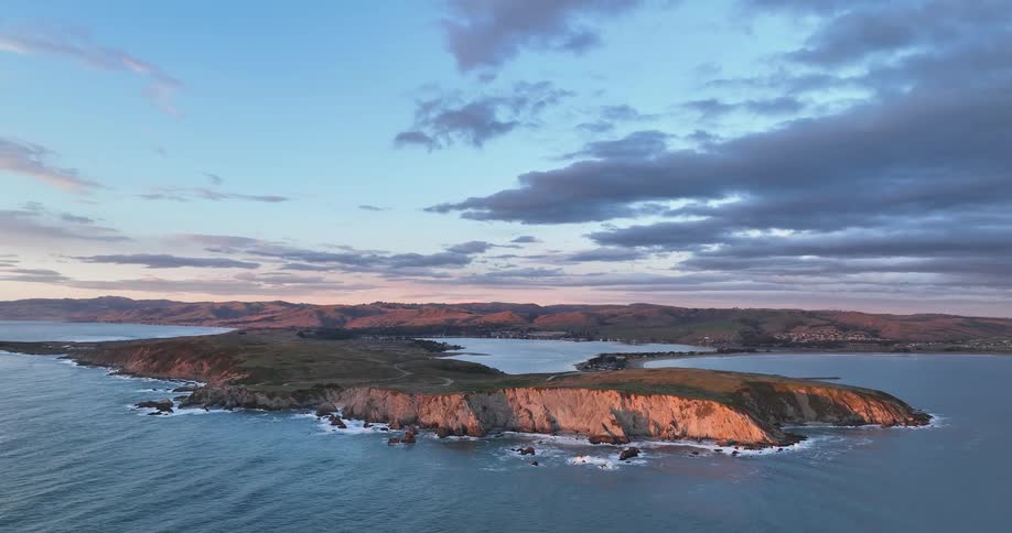 A headland and a coastal area with buildings