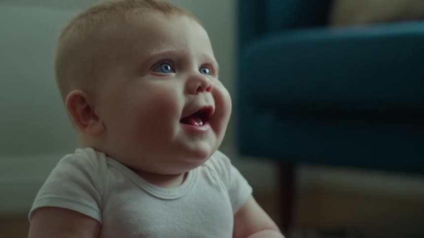 Portrait of a male baby opening his mouth and smiling