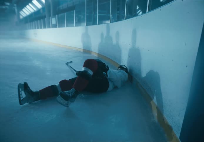 An injured hockey player lying on the court