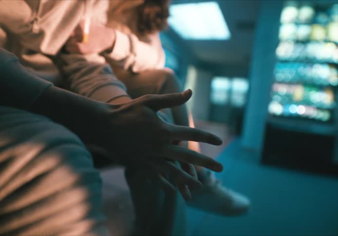 Two people sitting on the hospital bench with one of them with his leg bandaged