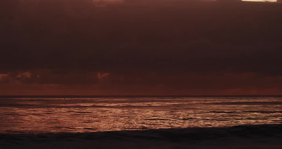 Beach with calm sea at dusk
