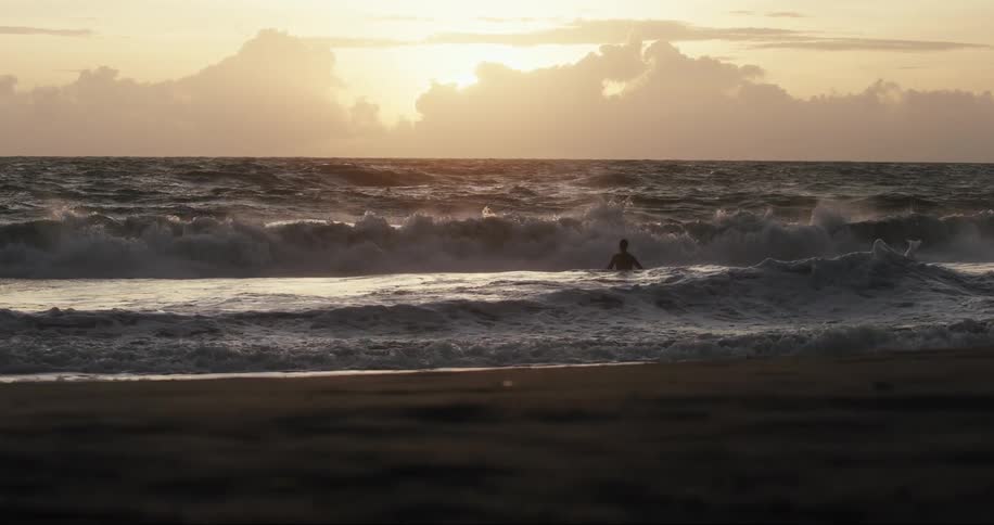 A person walking in the surf