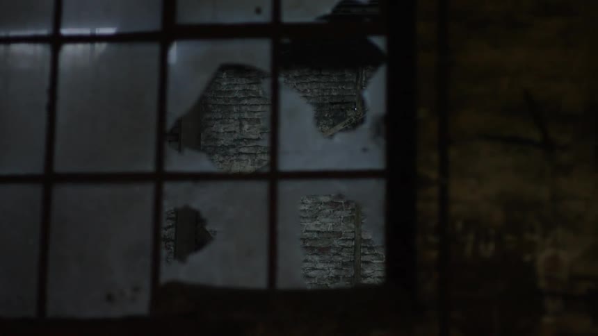 A broken window in a decrepit building