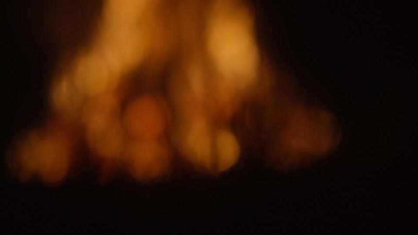 A large fire burns outdoors