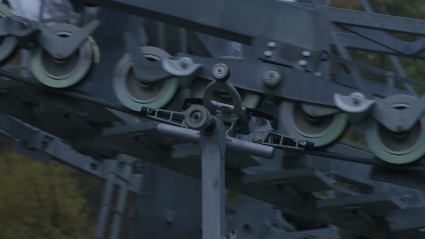 An iron machine passing through a cable connected to pulleys and is rising