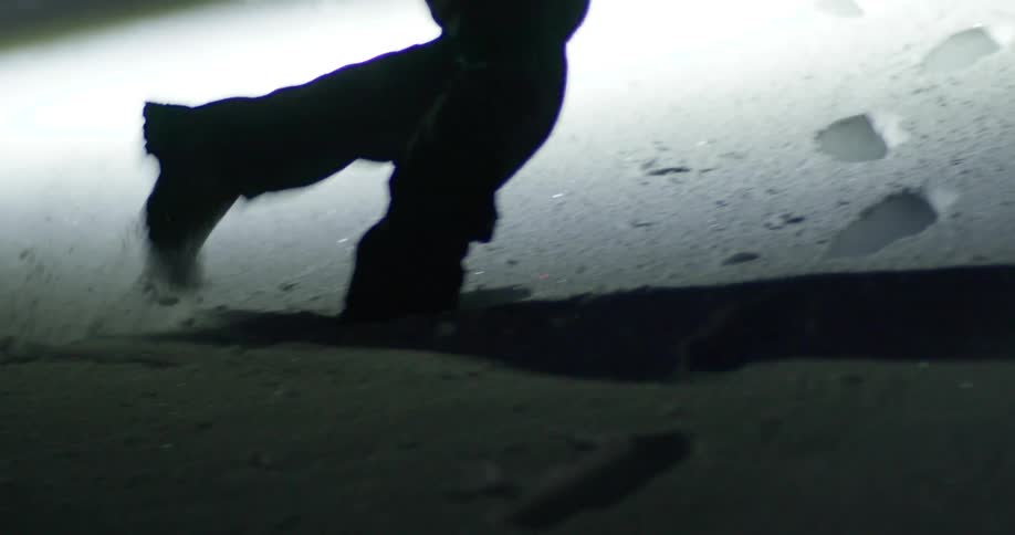 A person walking in the snow during a cold night