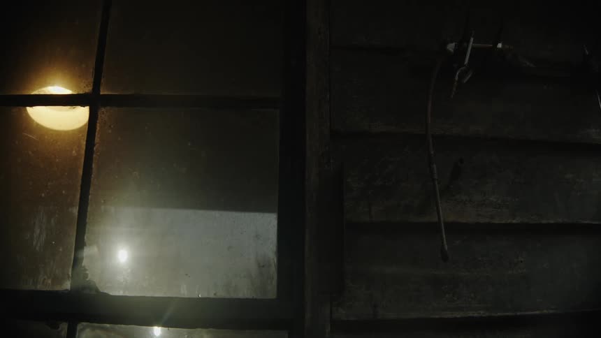 An object hangs on the side of a wooden house