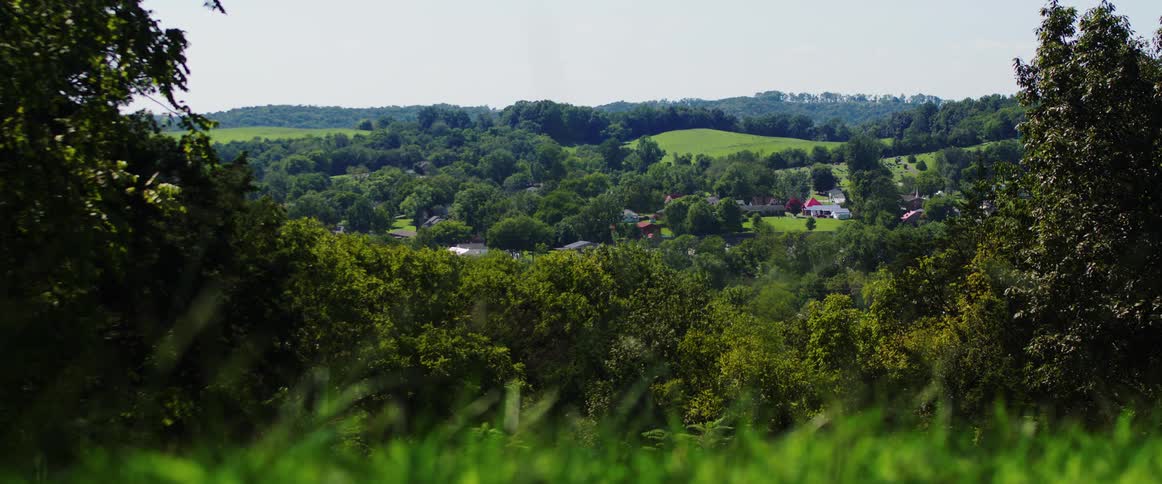 Landscape of a hill and rural houses on the horizon