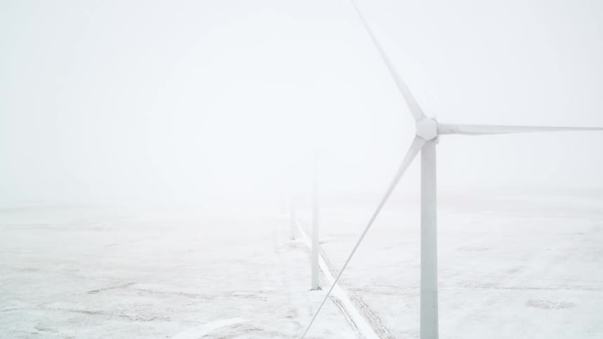 Aerial of a wind farm, frozen during winter