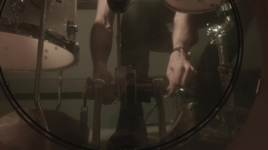 Man tying his boot laces and testing the musical drum lever