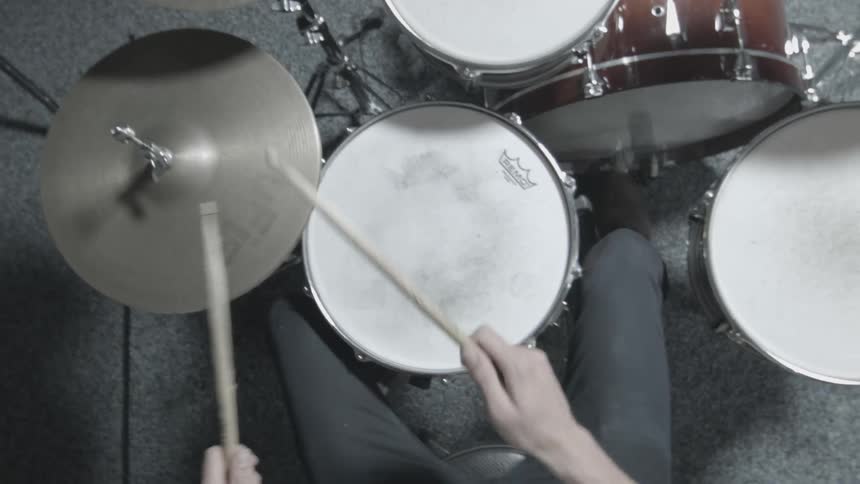 Downward view of a person playing the drums
